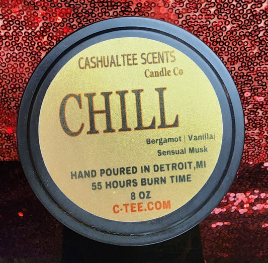 A item with a label that says CHILL WOOD WICK CANDLE – Bergamot, Vanilla, and Sensual Musk