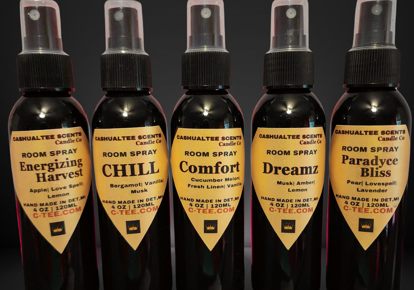 Five bottles of Cadesuahtlee Scents room spray with different scents on a dark background
