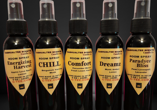 Five bottles of Cadesuahtlee Scents room spray with different scents on a dark background