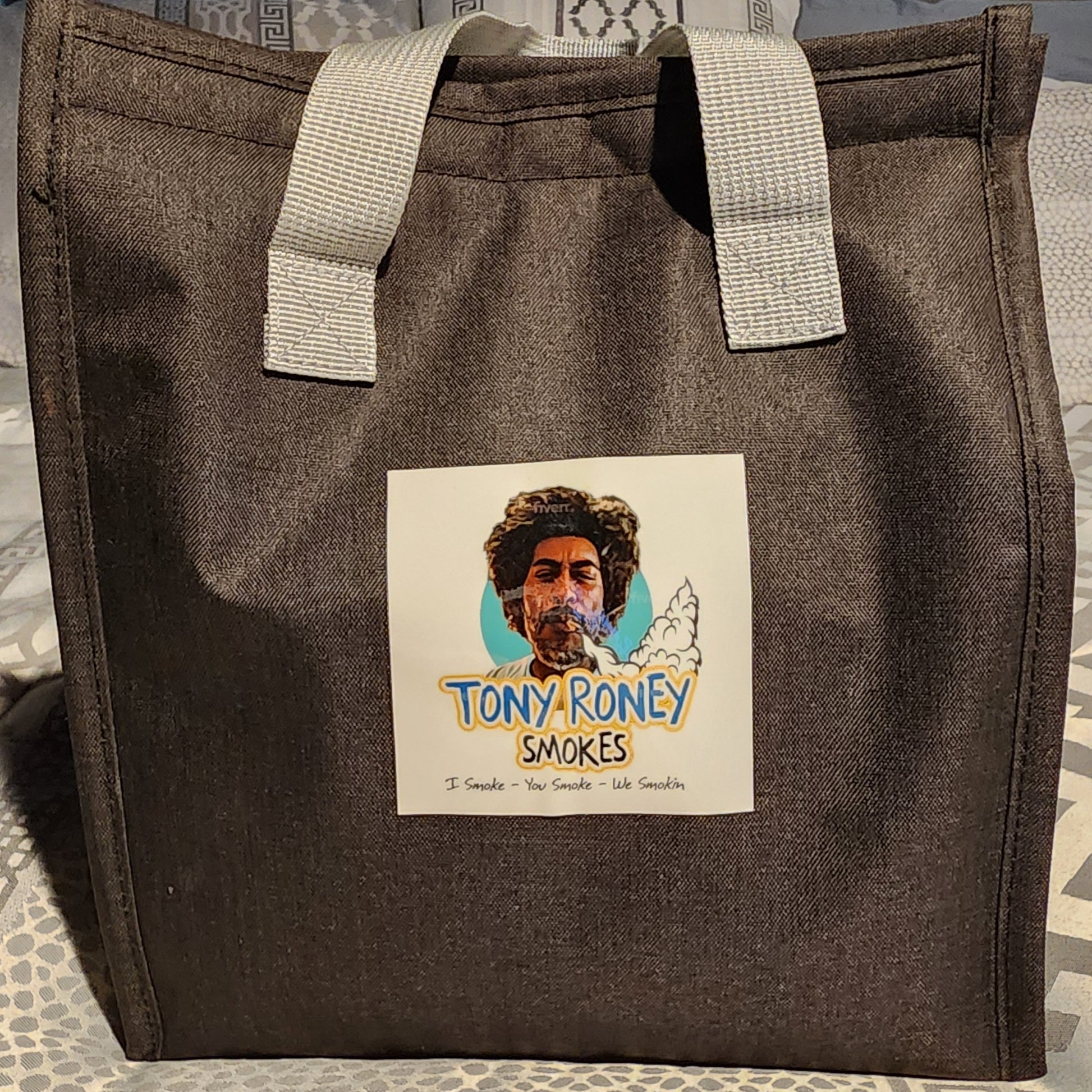 A BAG WITH A LABEL THAT SAYS TONY RONEY SMOKES TRAVEL BAG