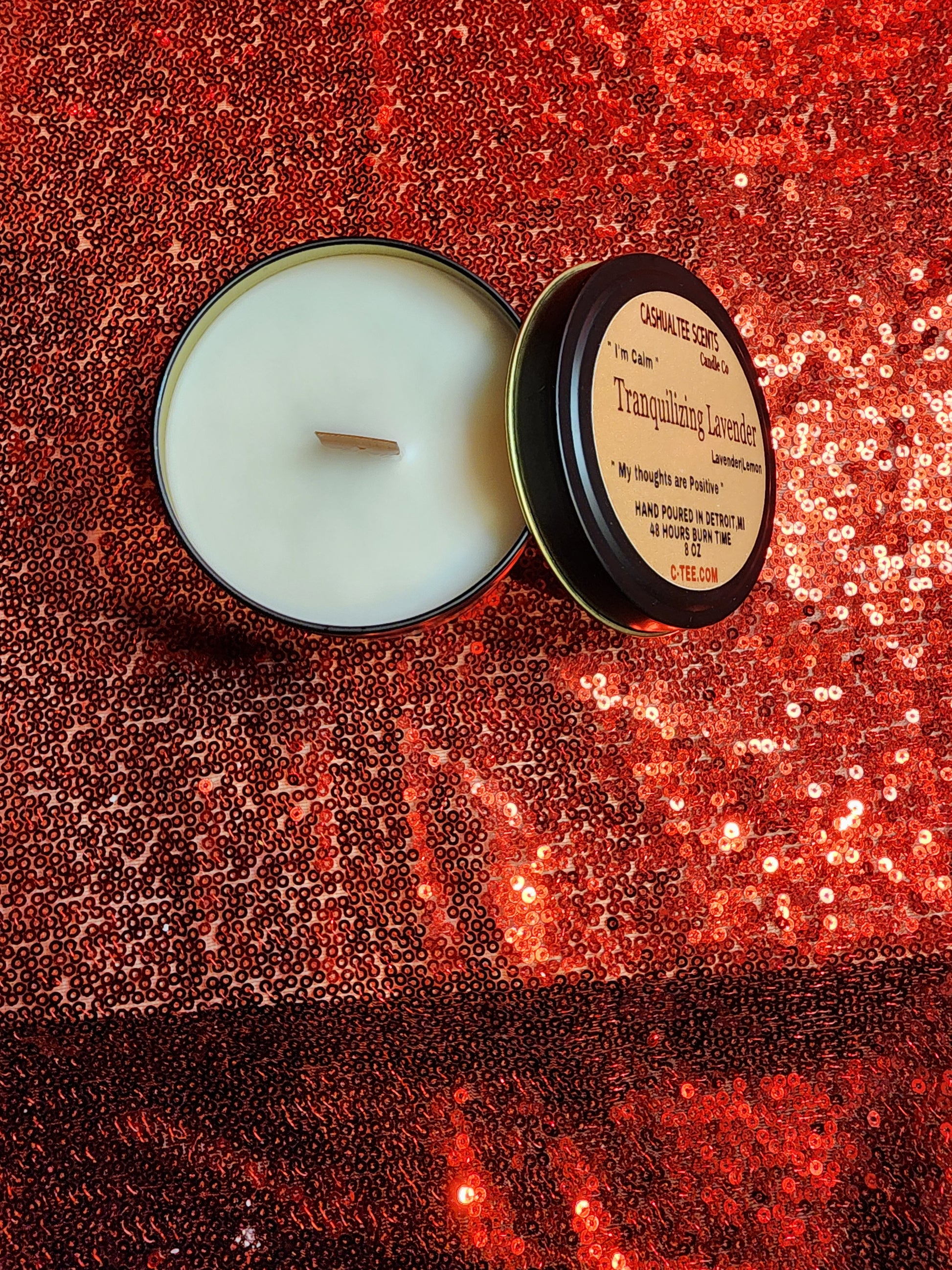 A candle with a label that says TRANQUILIZING LAVENDER WOOD WICK CANDLE – Lavender and Lemons.