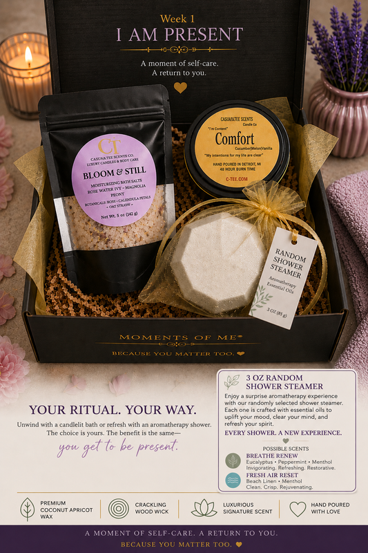 A curated self-care ritual gift set arranged in a black box with gold ribbon, including a black pouch labeled 'Bloom & Still,' a round tin labeled 'Comfort,' a wrapped shower steamer, and printed marketing text and icons below the box.
