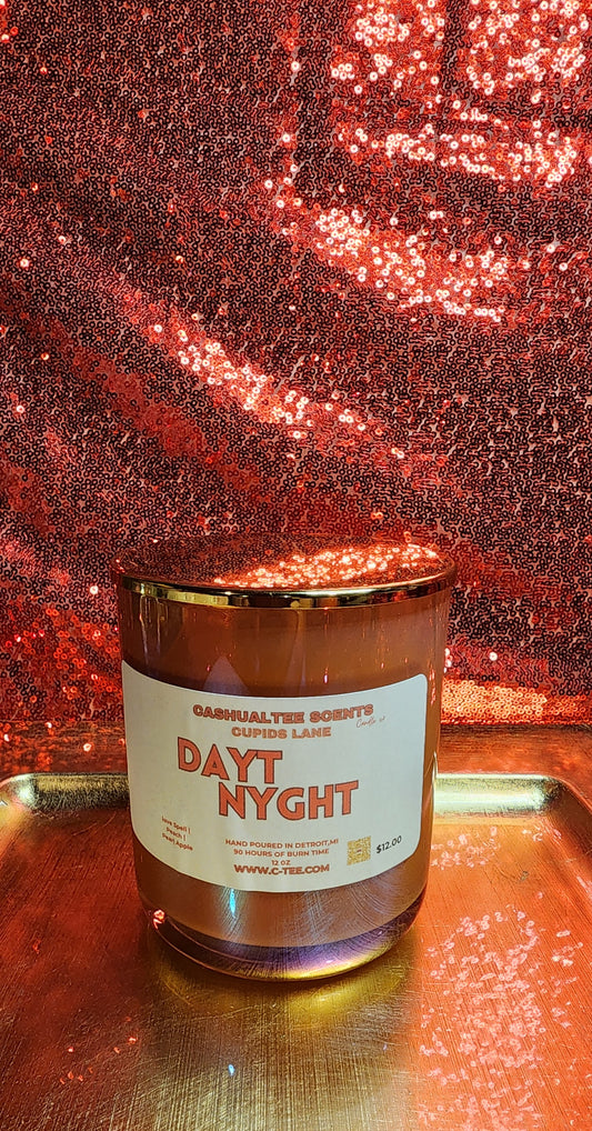 A candle with a label that says dayt nyght Lavender_ Lemons_ Love spell_ Apple